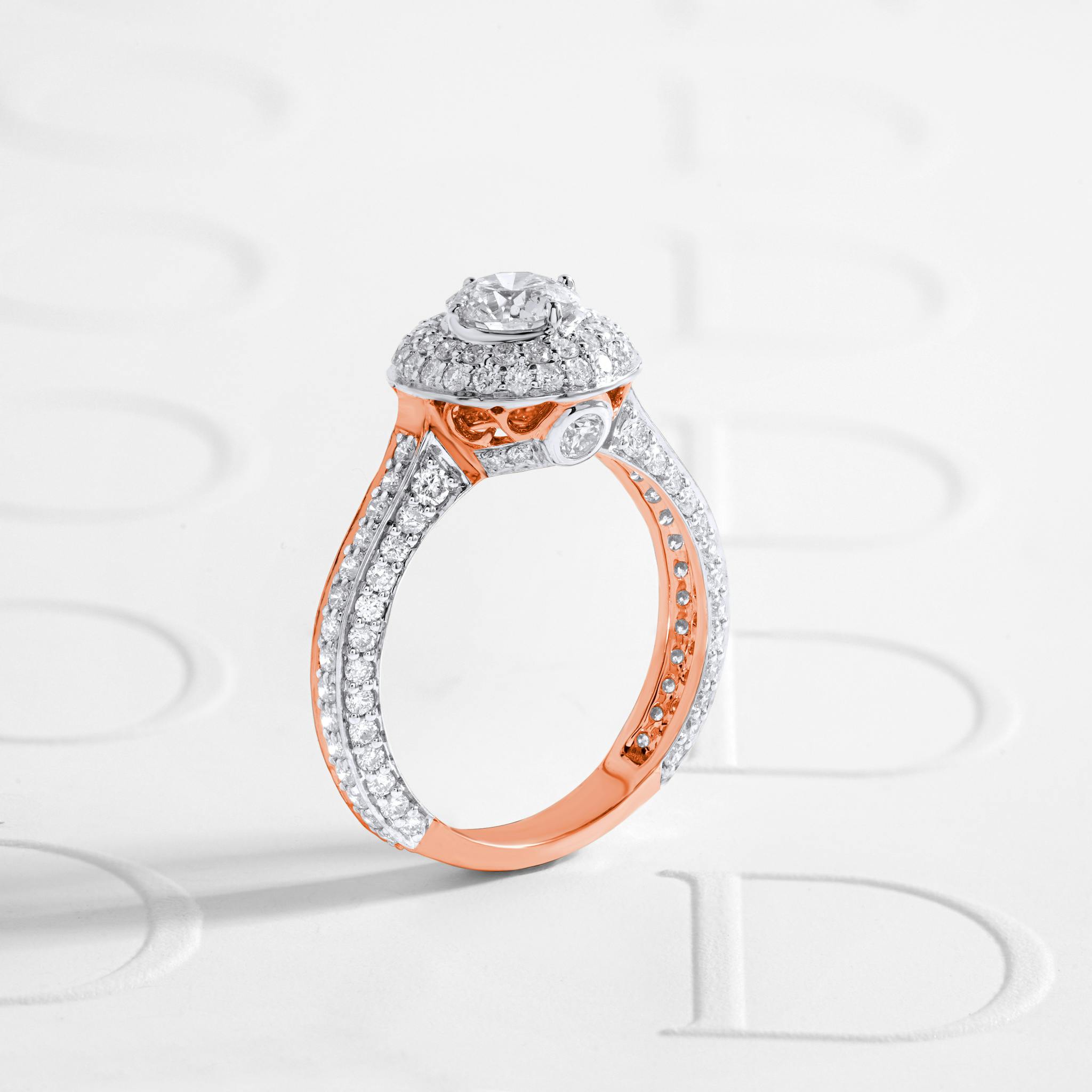 Glistening diamond ring with rose gold accents on a textured white background.