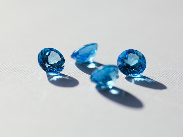 Loose blue fancy colour diamonds on white background – lab grown diamond supply Zahra Diamonds